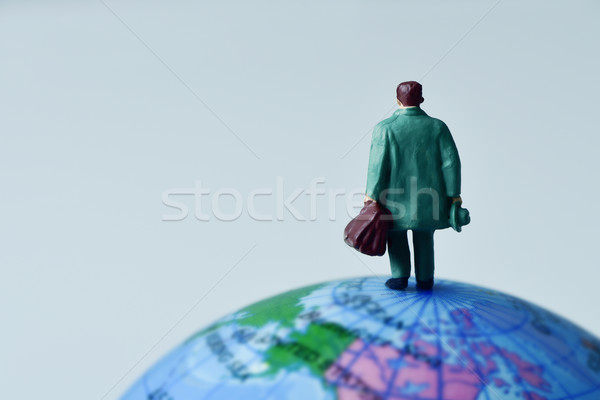 miniature traveler man on the terrestrial globe Stock photo © nito