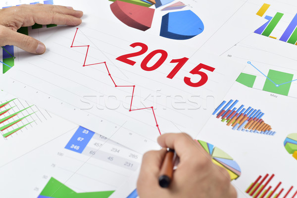 businessman observing a chart with a downward trend during 2015 Stock photo © nito