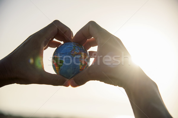 young man with a world globe in his hands  Stock photo © nito