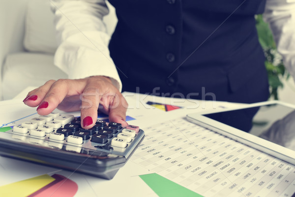 businesswoman using an electronic calculator in her office Stock photo © nito