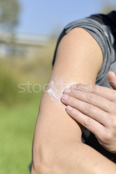 man applying sunscreen to his arm Stock photo © nito
