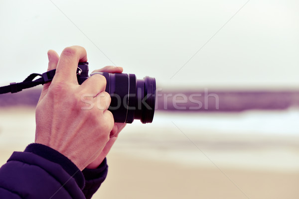 young man taking a picture in front of the sea Stock photo © nito