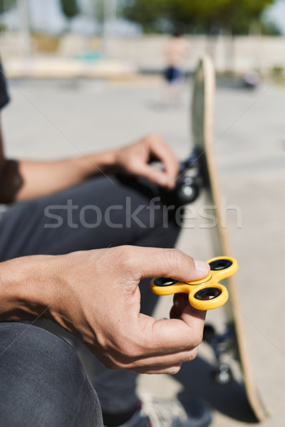 young man playing with a fidget spinner Stock photo © nito
