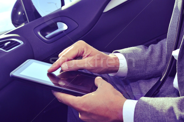 businessman using a tablet in a car Stock photo © nito