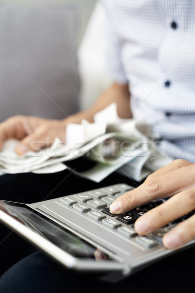 young man with bills and calculator Stock photo © nito