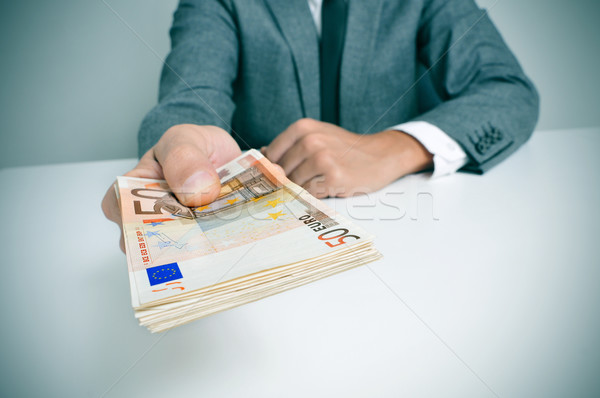 Férfi öltöny Euro számlák visel ül Stock fotó © nito
