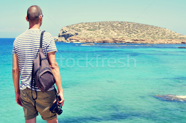 man looking at the sea and the Illa des Bosc island, in Ibiza, S Stock photo © nito