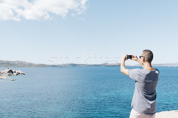 man taking a photo of the sea in Sardinia, Italy Stock photo © nito