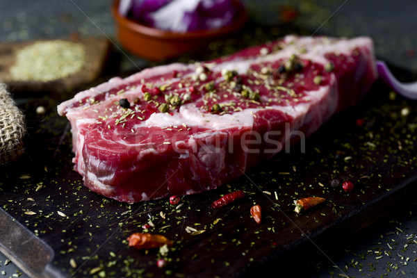 raw strip steak seasoned with different spices Stock photo © nito