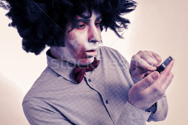 hipster zombie with an afro using a smartphone, with a filter ef Stock photo © nito