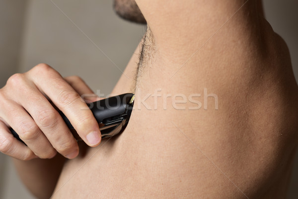 man trimming his armpit with an electric trimmer Stock photo © nito