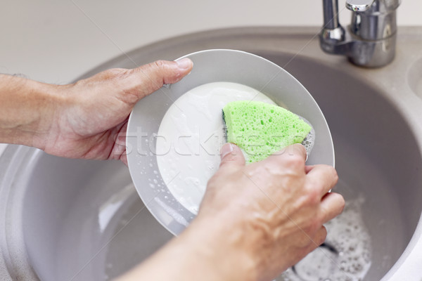 young man washing dishes Stock photo © nito