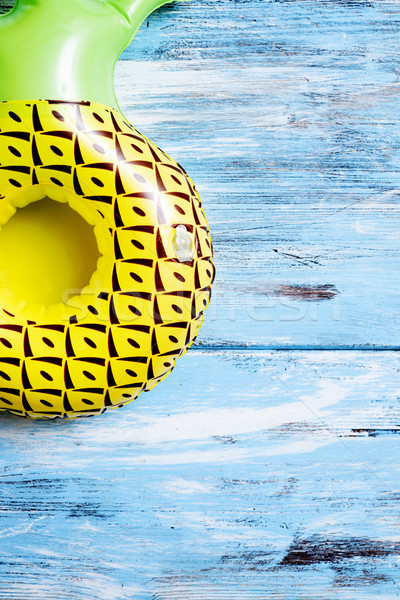 inflatable pineapple on a blue rustic wooden surface Stock photo © nito