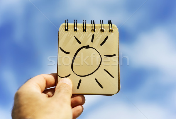 man and a sun in a notepad Stock photo © nito