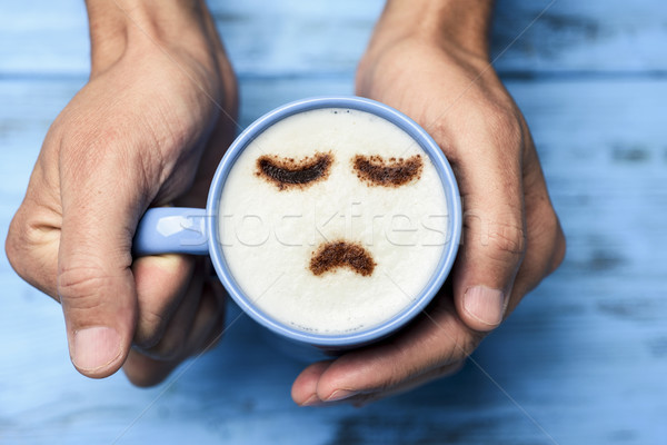 man with a cup of cappuccino with a sad face Stock photo © nito