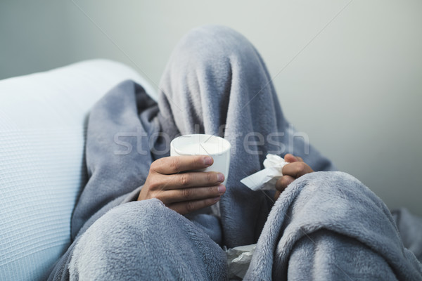 ill man warming up with a cup of hot milk Stock photo © nito