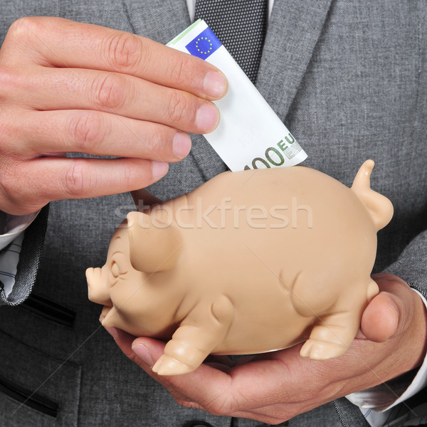 man in suit introducing a euro bill in a piggy bank Stock photo © nito