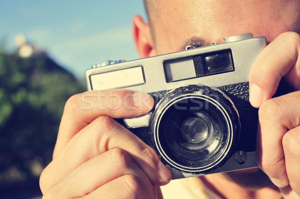 young man taking a picture with an old camera Stock photo © nito