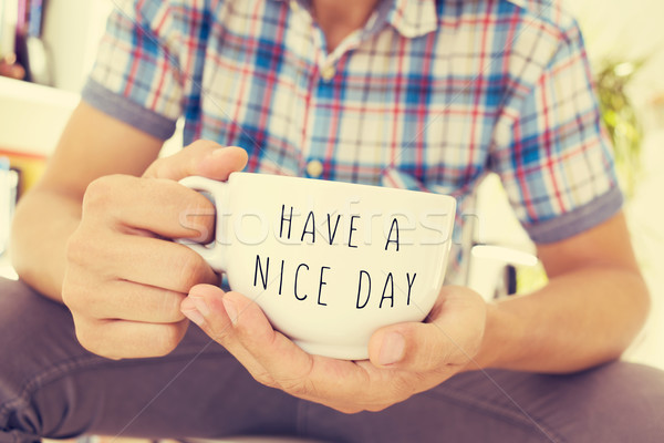 young man with a cup with the text have a nice day Stock photo © nito