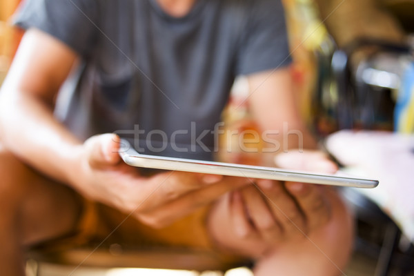 young man with a tablet computer in a rustic place Stock photo © nito