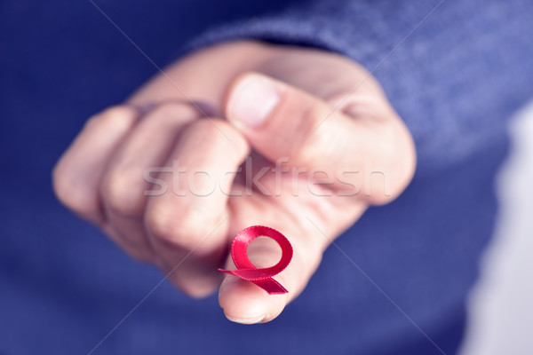 man with red ribbon for the fight against AIDS Stock photo © nito