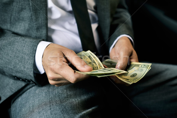 man counting dollar bills in the back of a car Stock photo © nito