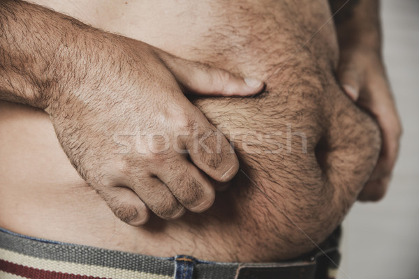 man grabbing the fat of his stomach Stock photo © nito