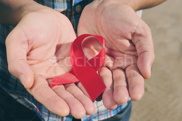 Vörös szalag verekedés AIDS szűrő hatás fiatalember Stock fotó © nito