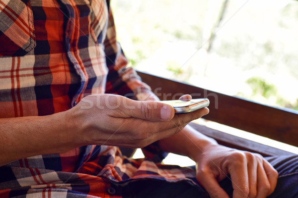young man using a smartphone outdoors Stock photo © nito