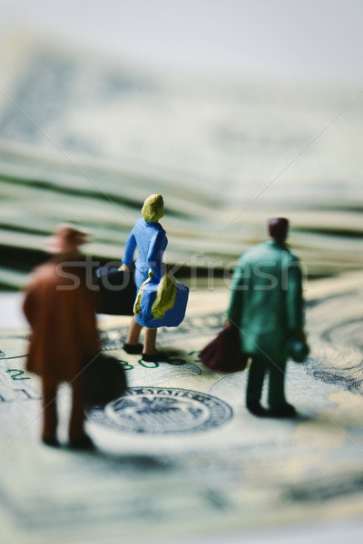 miniature travelers on dollar banknotes Stock photo © nito