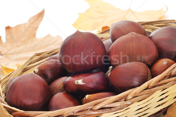 Stock photo: chestnuts and autumn leaves