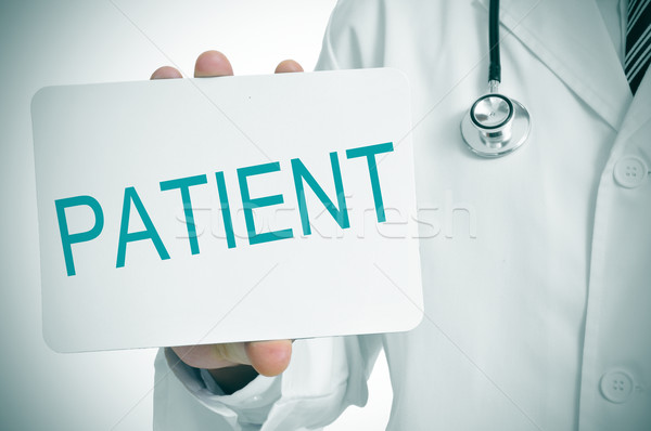 doctor showing a signboard with the word patient written in it Stock photo © nito