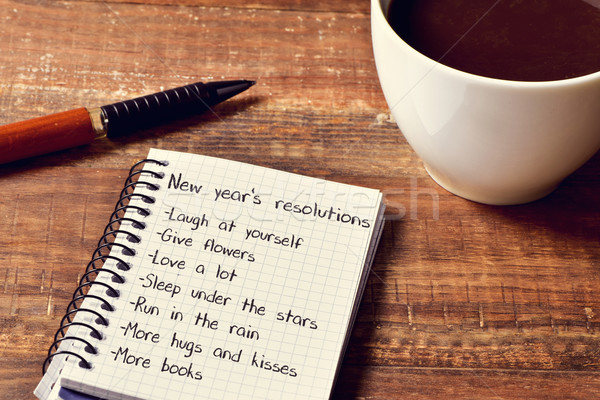 coffee and notepad with a list of new years resolutions Stock photo © nito