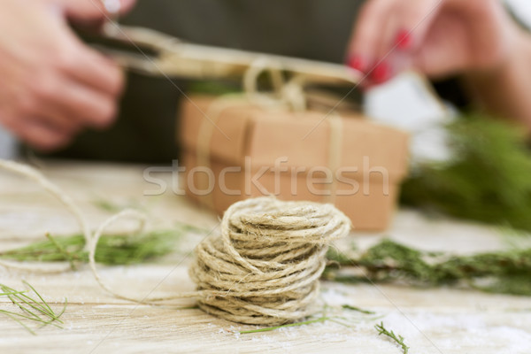 woman tying a string around a gift Stock photo © nito