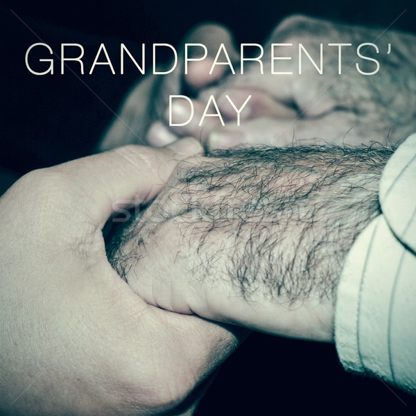 young man holding the hands of an old man and the text grandpare Stock photo © nito