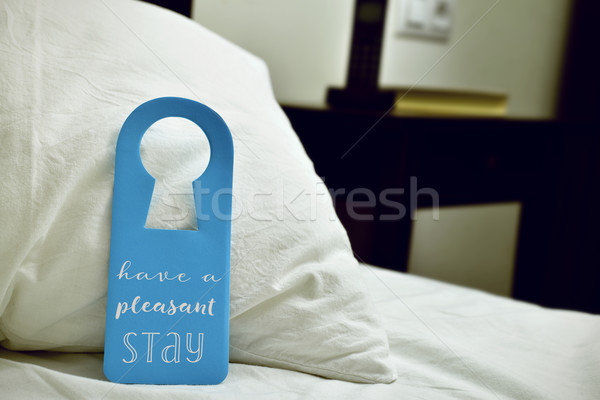 Stock photo: text have a pleasant stay in a door hanger