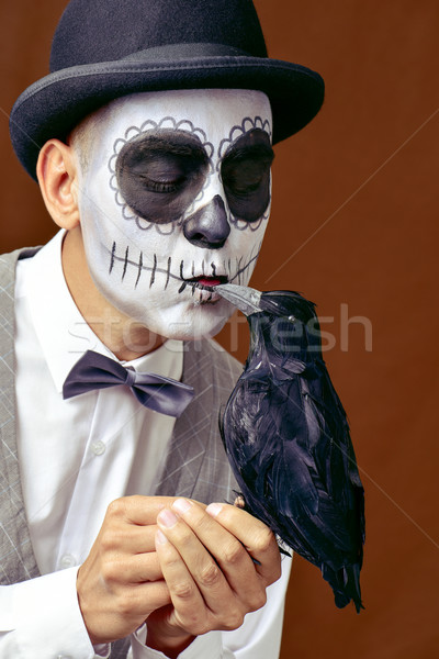 man with mexican calaveras makeup kissing a black crow Stock photo © nito