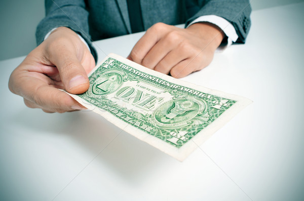 man in suit offering a one US dollar bill Stock photo © nito