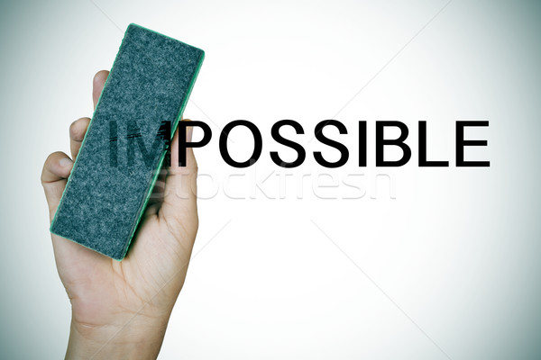 deleting the word impossible with an eraser Stock photo © nito