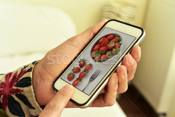 picture of a bowl with strawberries in a smartphone Stock photo © nito