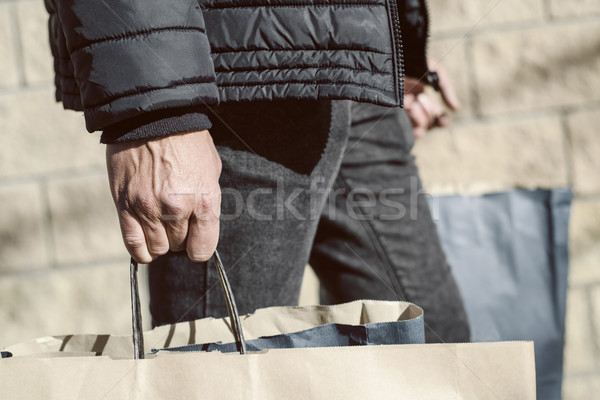 young man with some shopping bags on the street Stock photo © nito