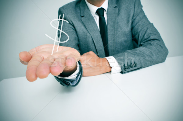 Biznesmen znak dolara posiedzenia biurko Zdjęcia stock © nito