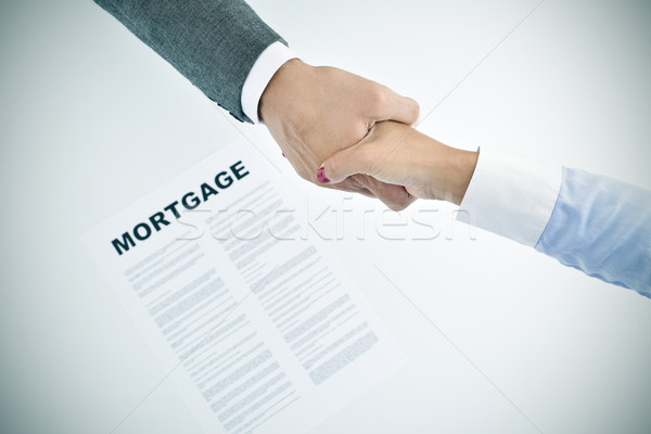 mortgage loan and man and woman shaking hands, vignetted Stock photo © nito