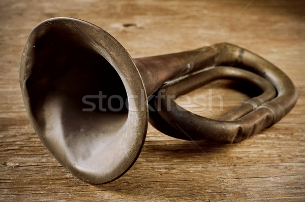 old bugle on a wooden surface Stock photo © nito