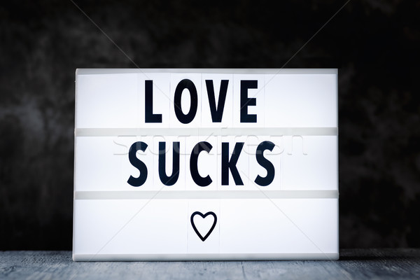 Stock photo: text love sucks in a lightbox