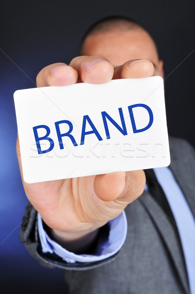 young man in suit shows a signboard with the word brand Stock photo © nito