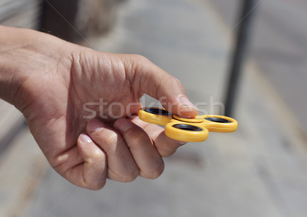 young man playing with a fidget spinner Stock photo © nito