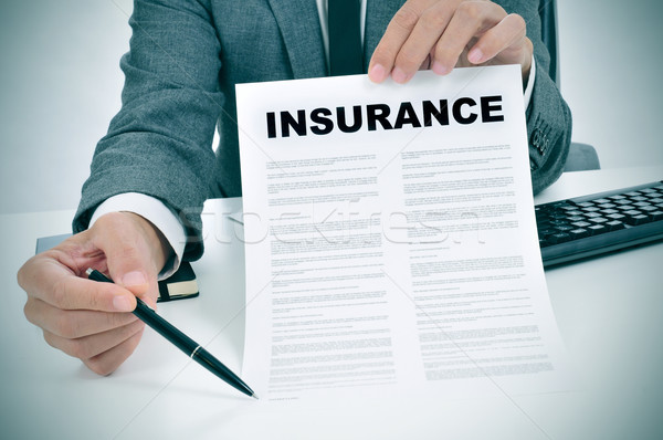young man in suit showing an insurance policy Stock photo © nito