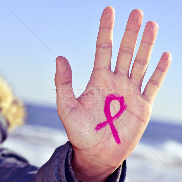 young man with a pink ribbon for the fight against cancer in his Stock photo © nito