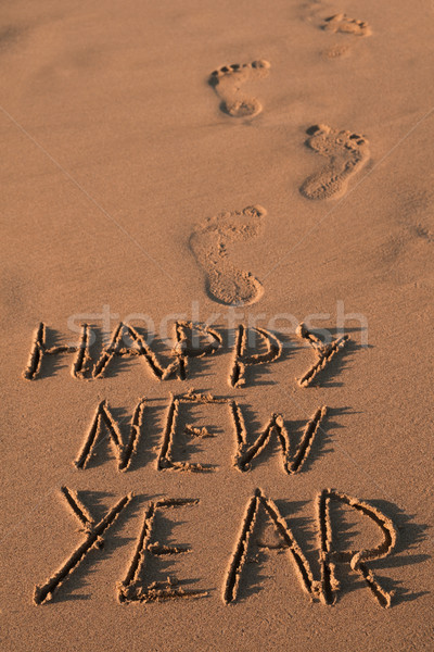 text happy new year in the sand of a beach Stock photo © nito